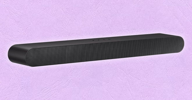 A long black soundbar with curved ends in front of a light pink background.