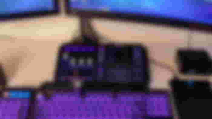 A GoXLR with purple and blue lighting sits above an RGB keyboard