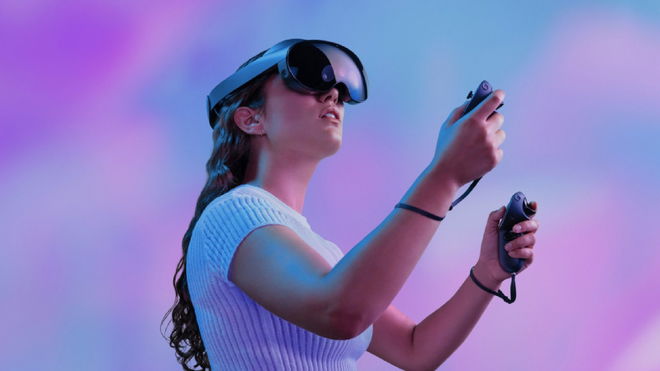 Person wearing the Meta Quest Pro in front of a purple-like background