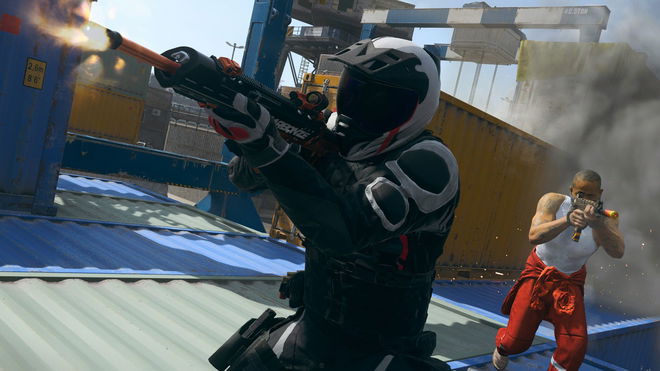 Warzone players aiming down sights of guns while standing on shipping containers