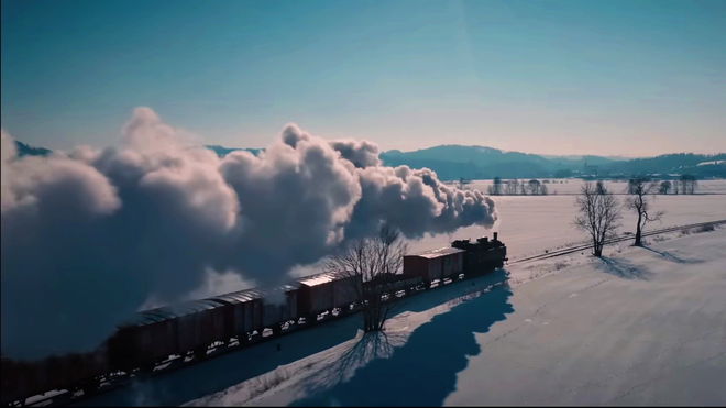 Last Train Home - steam train with carriages travelling through snow
