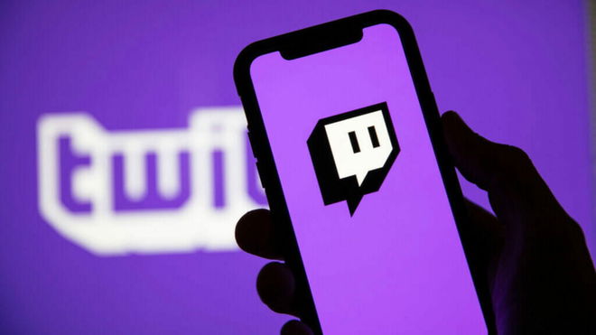 Twitch drops - A hand holds a phone showing the Twitch logo