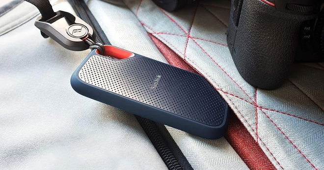 A blue and grey SSD with red trim connected to a white and red rucksack.