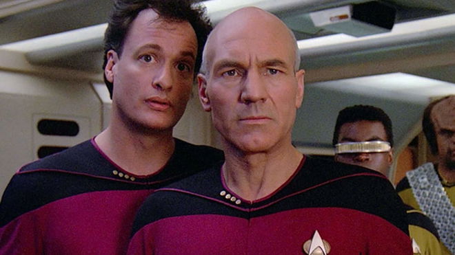 Jean-Luc Picard and Q standing on the bridge of the Starship Enterprise