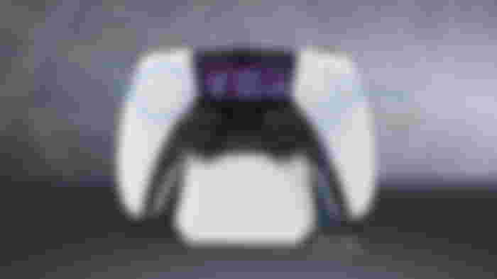 A white and black PS5 controller-style alarm clock.