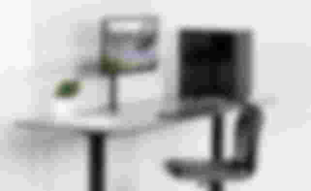 Vivo product image of a black single arm with a monitor mounted sat on a desk next to a PC.