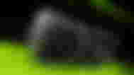 an nvidia rtx 3070 graphics card is sitting on top of a green surface .