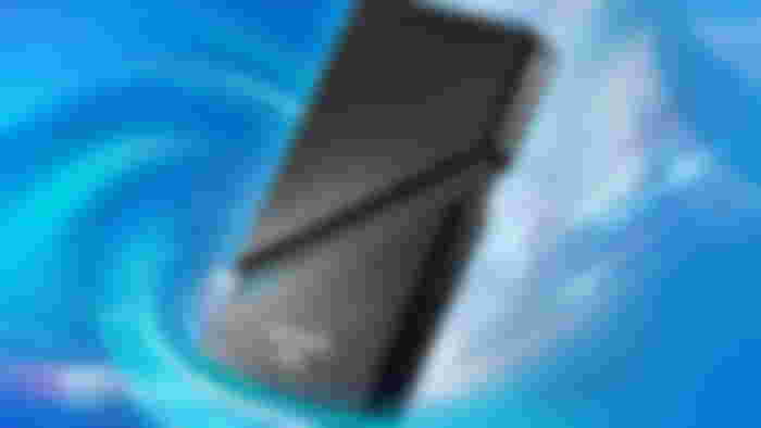 A black ADATA external SSD in front of a blue background.