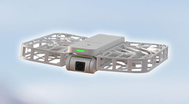 A small white drone with a lightweight lattice structure on each wing.