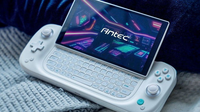A white Antec Core HS gaming handheld on a blanket with the screen slid up to reveal a keyboard