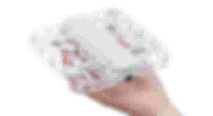 A white HOVERAir X1 drone in the palm of a hand.