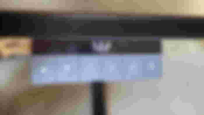 Close-up of the Bouiles MagVida desk's black and grey height adjustment control panel.