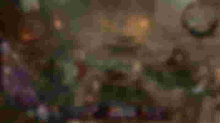 Baldur's Gate 3 review - Voldo the Author singing on a fire in front of an army of goblins