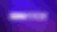 HBO Max logo in white in front of a gradient purple background.