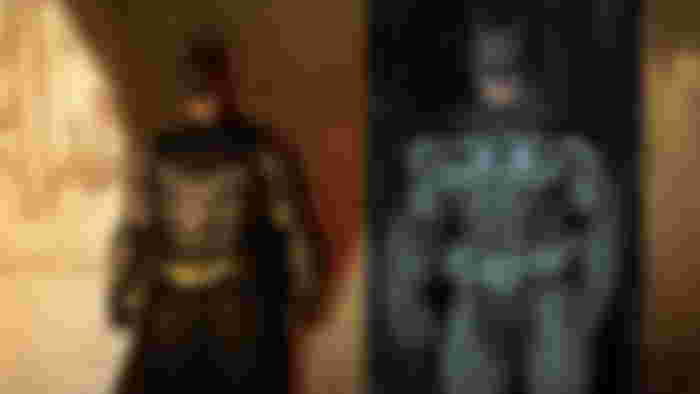 Arkham Shadow key art with Batman standing in front of a wall, next to an image of Batman from Arkham Origins