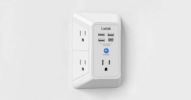 A white power outlet extender with multiple USB and wall plug ports to connect to.