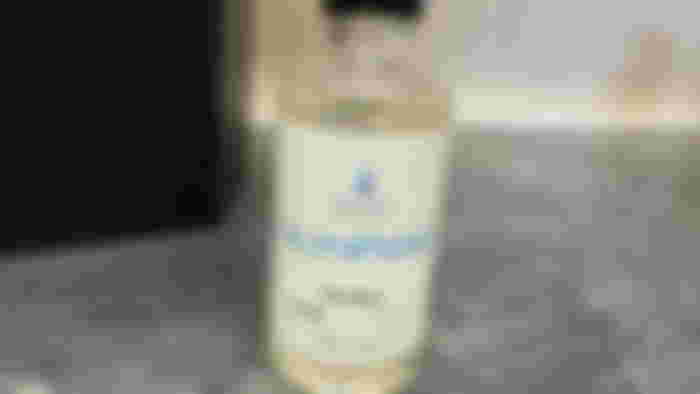 Gunfire scent bottle for the Gamescent standing on a marble countertop