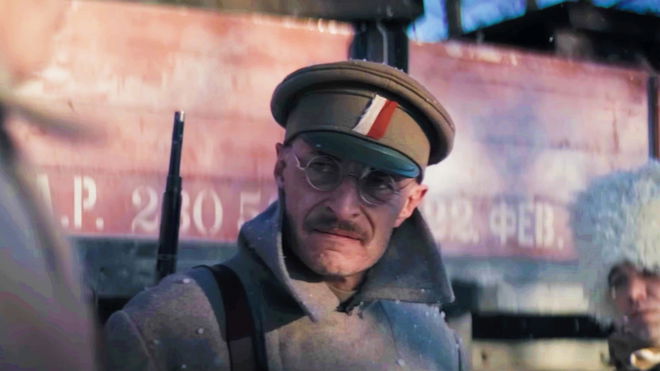 Last Train Home - soldier wearing a cap with a red and white stripe, with a rifle on his back