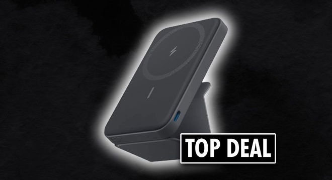A dark grey and black portable battery pack propped up on a stand with a "TOP DEAL" label in black and white next to it.