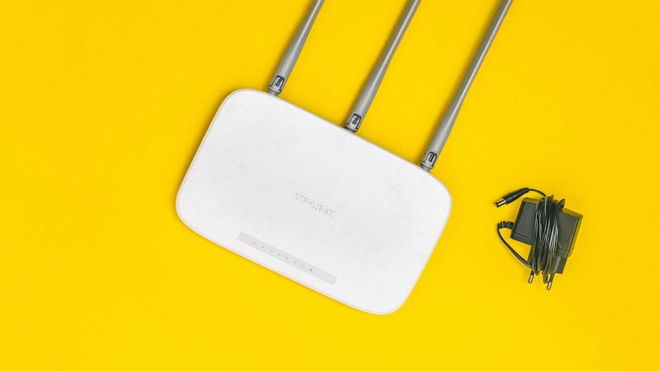 TP-Link error code 80002 - An image of a white TP-Link router on a yellow background
