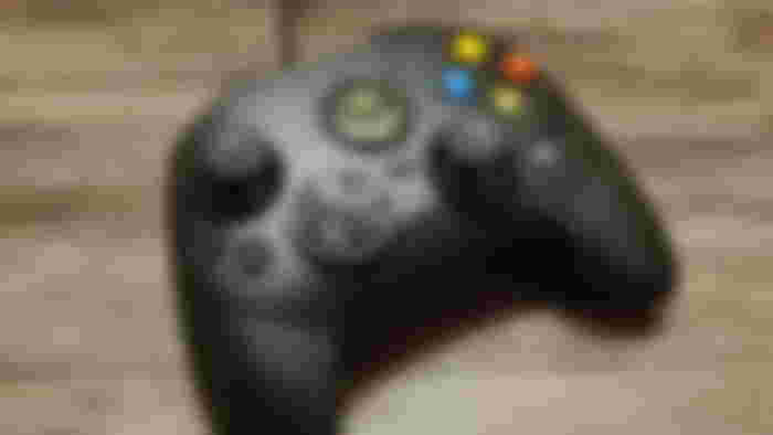 The Hyperkin Duchess Original Xbox S controller on a wooden table