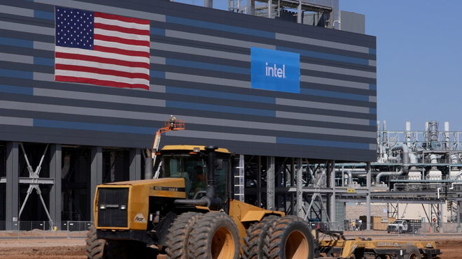 intel logo and US flag at construction site with yellow machine