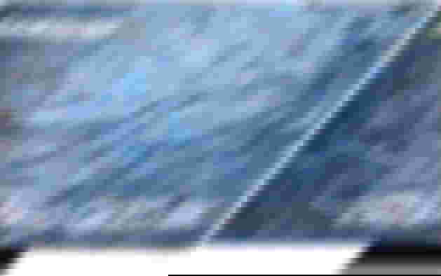 Samsung QE85QN900C product image of a black near-frameless TV featuring blue rippling water on the display.