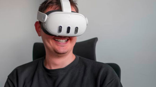 A user wearing a Meta Quest 3 VR headset while smiling