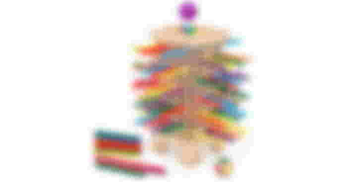 A wooden tower game with multicolored sticks poking through it and a purple ball waiting to go through above.