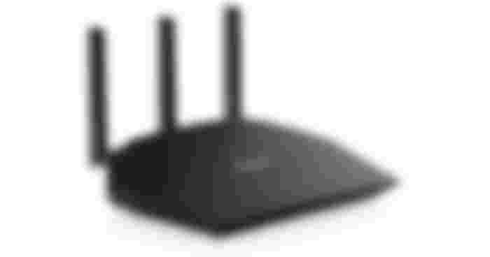 NETGEAR R6700AX product image of a black WiFi router with five green lights on the front and three antennae coming out the back.