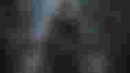 The Hunter from Bloodborne standing inside a Samsung Odyssey G8 monitor for PC