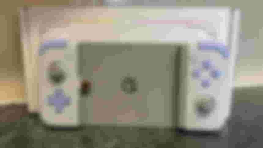 Gamesir X2s in front of the box and a tiled wall