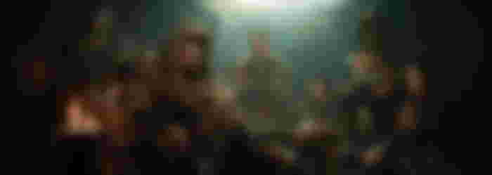 A group of figures in a dimly lit room