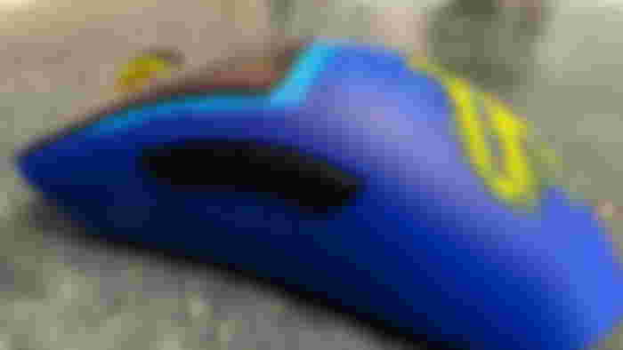 Close-up of the side view of the Fortnite x Razer DeathAdder mouse, showcasing the blue and yellow colors