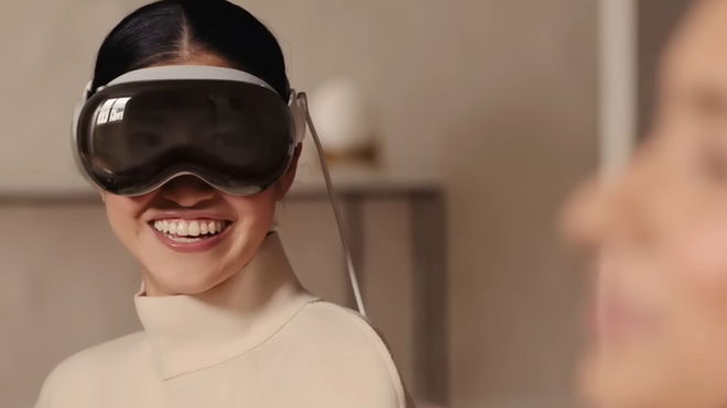 A woman wearing the Apple Vision Pro with a big smile
