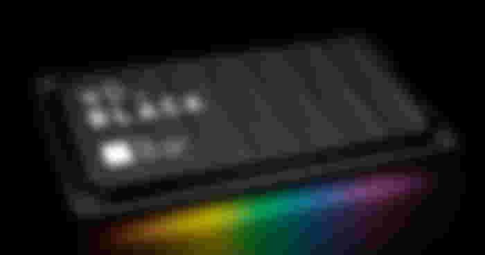 A black SSD with white "WD_BLACK" branding on top above multicolored lighting.