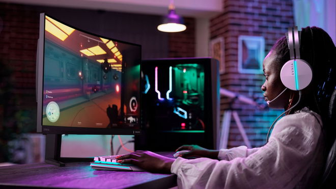 Philips Evnia 32M2C5500W gaming monitor on a desk, with a gamer using it to play a first-person shooter
