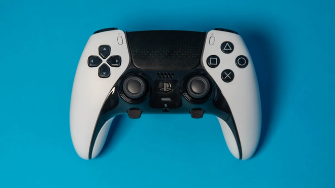 white and black playstation 5 controller on blue background