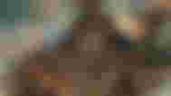 Hephaestus' portrait in Hades 2, with him holding a large hammer over his shoulder.