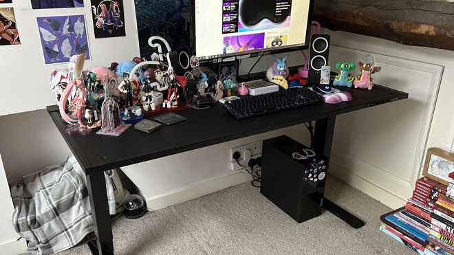 Secretlab MAGNUS Pro desk with monitor attached and plenty of items sitting on top of it