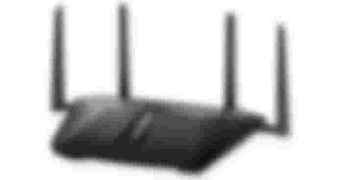 NETGEAR Nighthawk RAX50 product image of a black WiFi router with four antennae sticking out of the back.