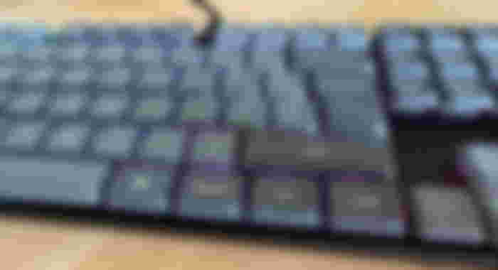 RGB lighting below the grey key caps of the Keychron K5 Max.