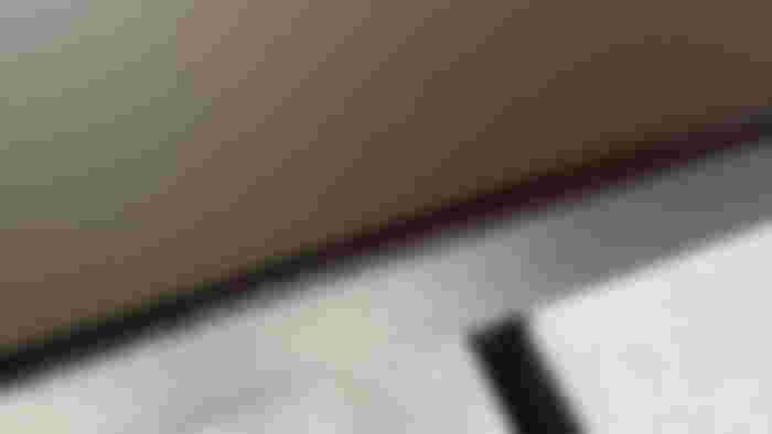 Close-up of a black MagVida's desk textured surface.