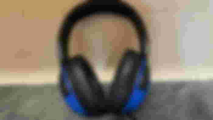 A pair of Razer x Fortnite Kraken V3 X headphones sitting on a marble countertop