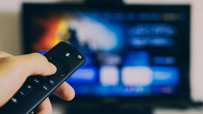 A person using an Amazon Fire TV device 