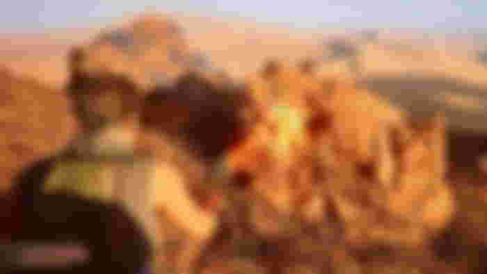 Player character using a laser tool to mine rocks in Dune Awakening