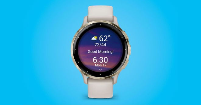 A gold smartwatch with an ivory-coloured strap in front of a blue background.