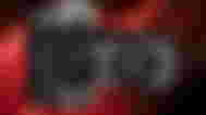 AMD 7600 XT in front of an AMD press image which is blurred