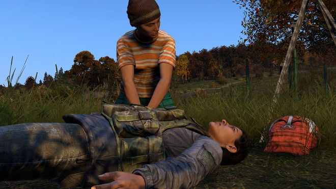 Image of DayZ reviving injured player with blue sky and trees in background