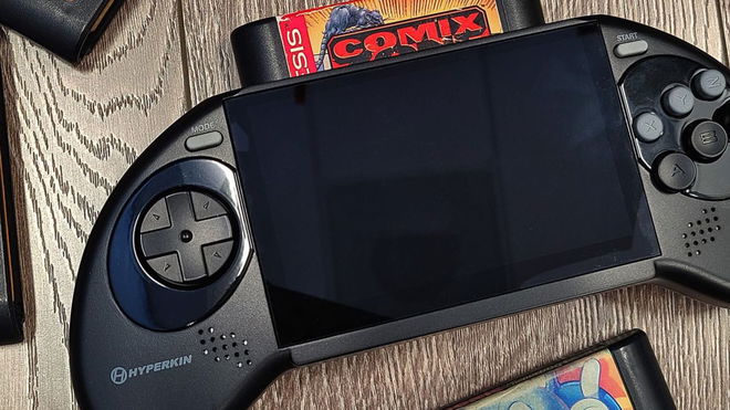 The Hyperkin Mega95 portable SEGA Genesis console resting on a wood grain table 